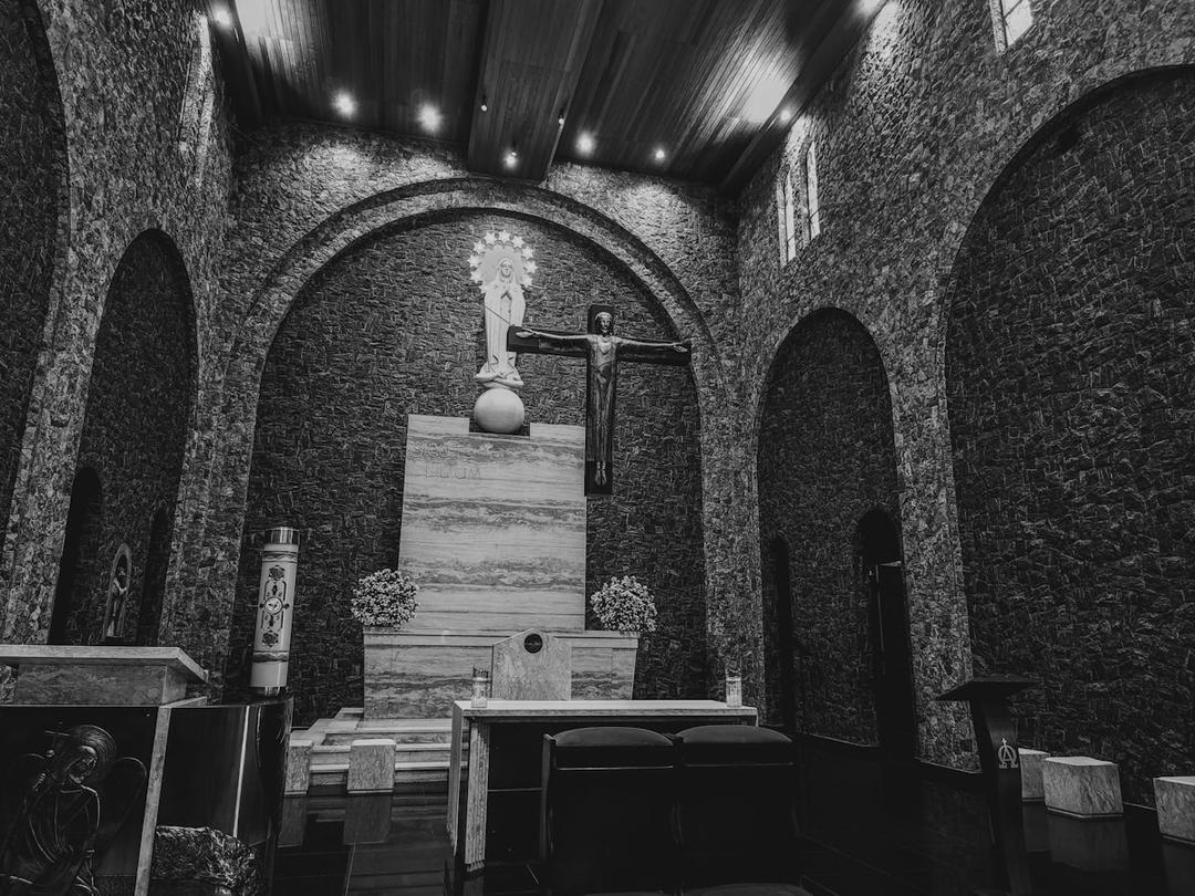 Interior of a historic Christian cathedral with altar and devotional statues