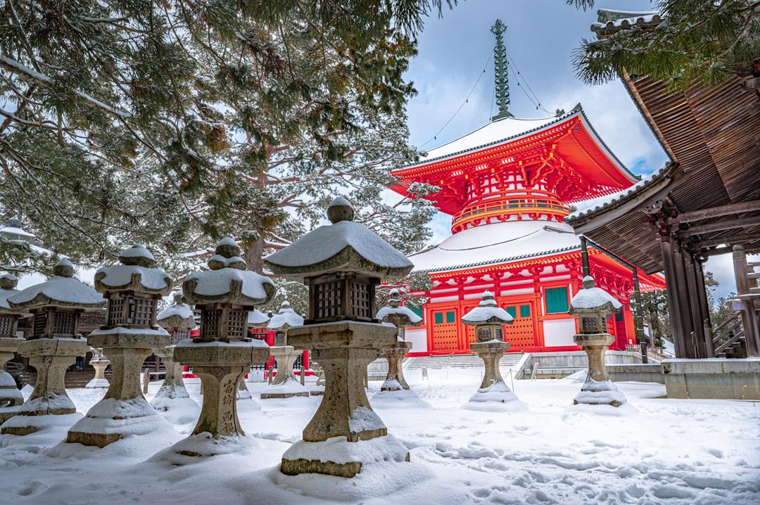Snow-covered temple among ancient cedars on Mount Koya, Japan