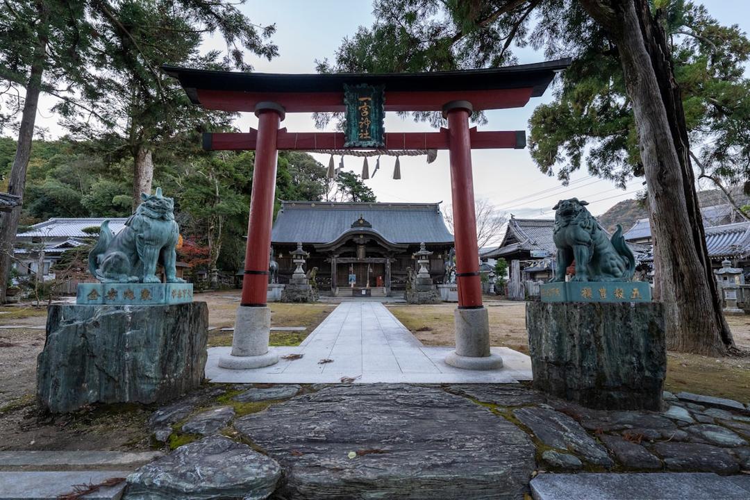 Pilgrim walking past a temple gate on the Shikoku 88 Temple trail in Japan